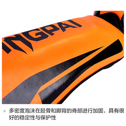 Kickboxing shin guard pads in vibrant orange color with sleek black design for enhanced stability and protection.