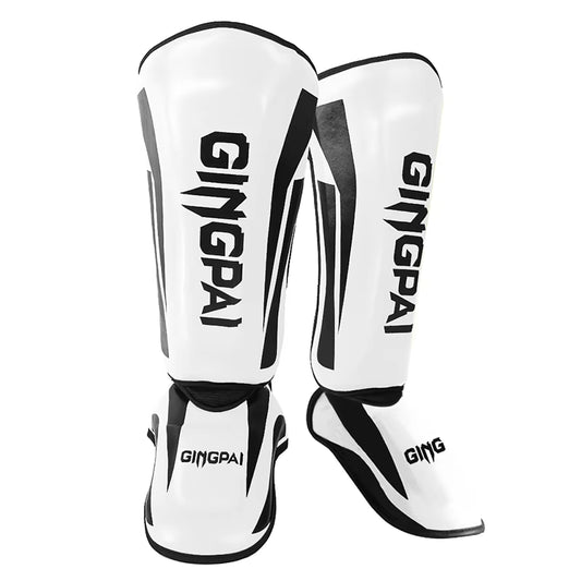 kickboxing shin guard pads in white with black accents for martial arts training and protection.