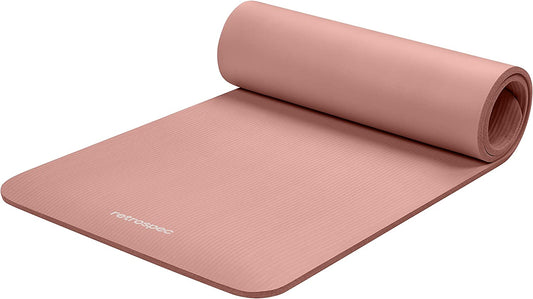 extra thick non-slip yoga mat in soft pink color rolled out on the floor for yoga and exercise.