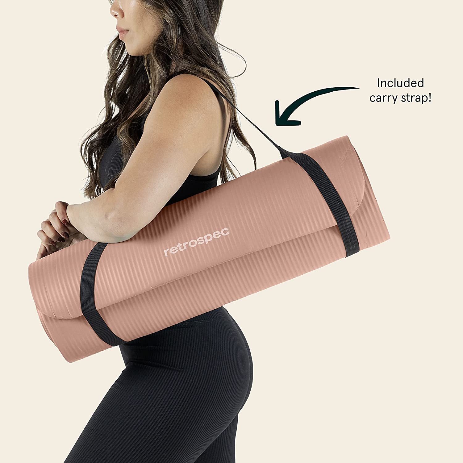 Woman carrying a Solana extra thick non-slip yoga mat with included strap over her shoulder.